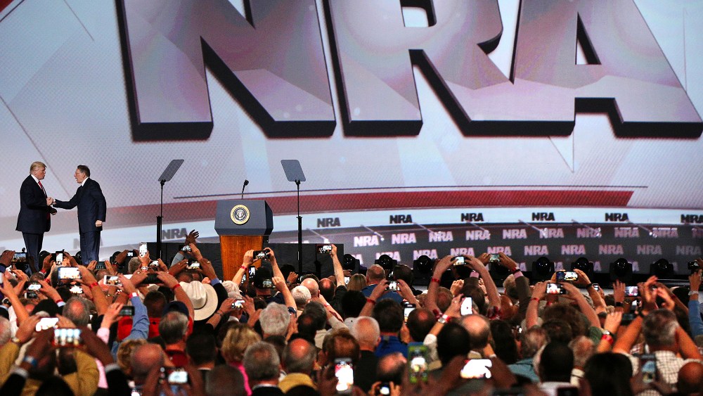 Image: President Donald Trump shakes hands with NRA Executive Vice President Wayne LaPierre