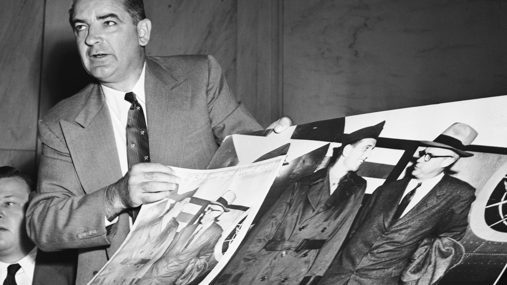 Image: Joseph McCarthy Holding Large Photographs