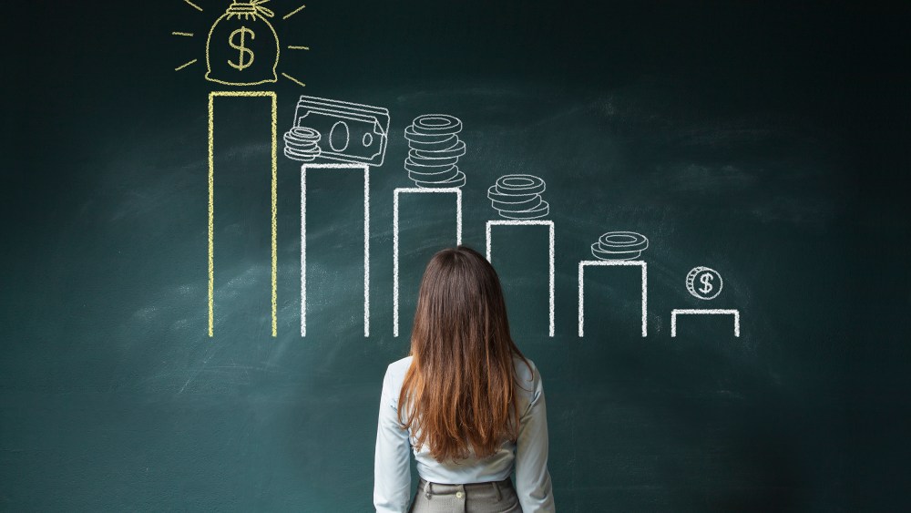 Image: Businesswoman looking at a financial chart on chalkboard
