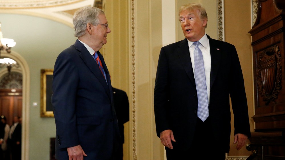 Image: President Donald Trump stops to speak with members of the media as he attends the Senate Republicans' weekly policy lunch