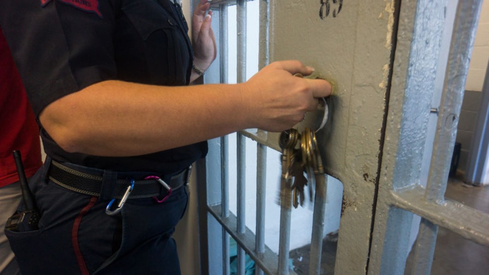 A prison guard opens a locked door with keys inside Angola prison.