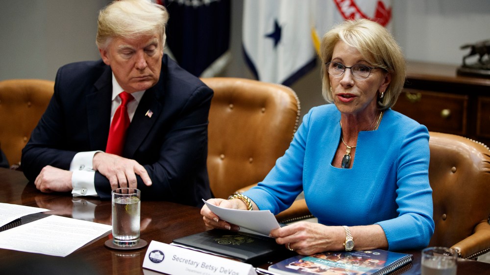 President Donald Trump listens as Secretary of Education Betsy DeVos speaks discusses the Federal Commission on School Safety report