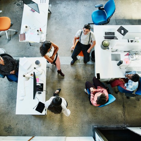 Overhead view of design team having project meeting in office