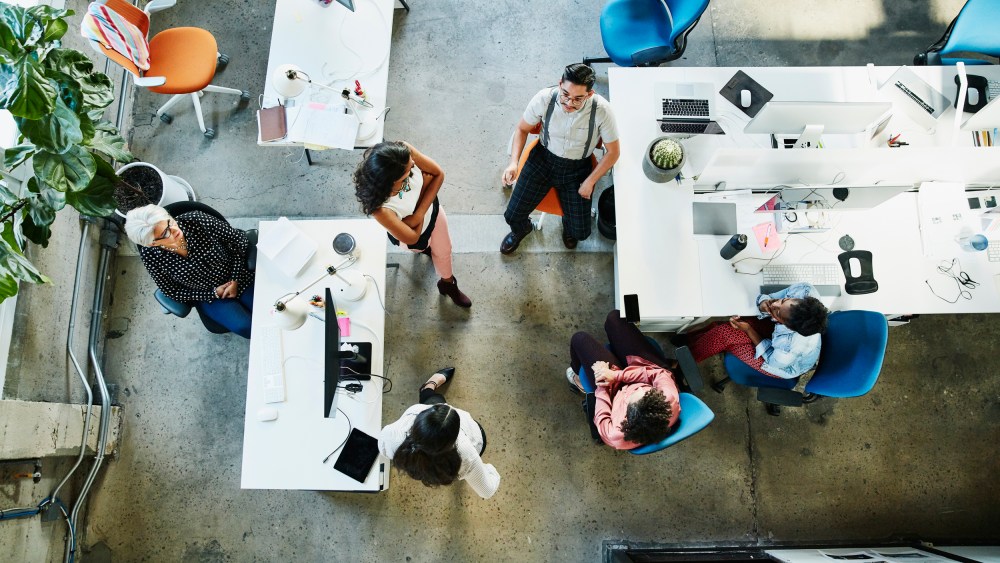 Overhead view of design team having project meeting in office