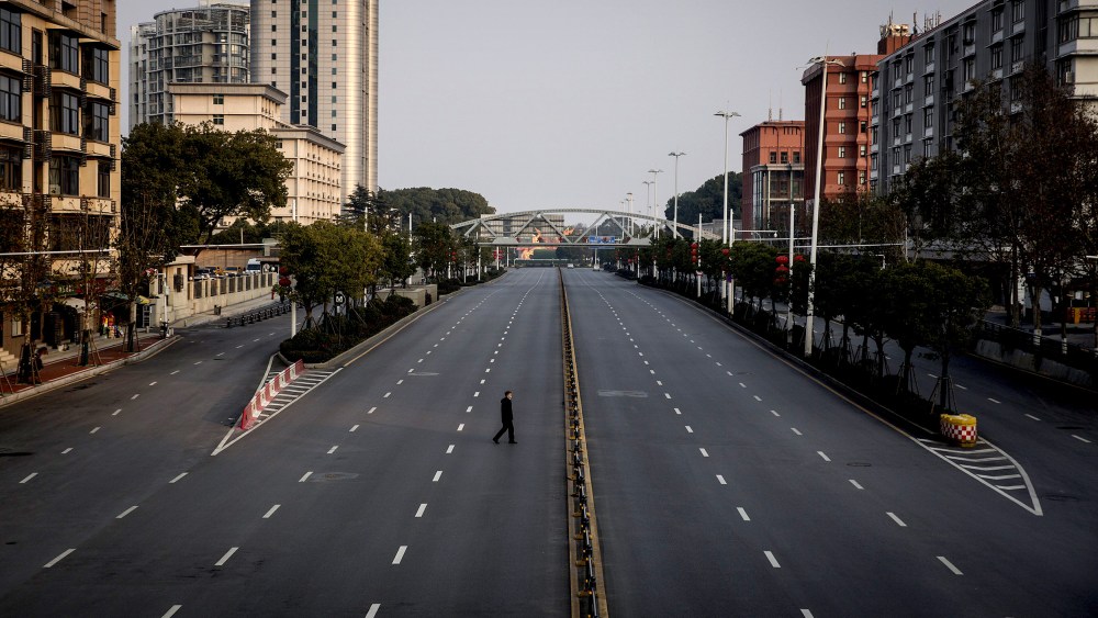 Image: A man crosses an empty highway in Wuhan, China, on Feb. 3, 2020. The coronavirus, which has now spread to several countries, originated in Wuhan.