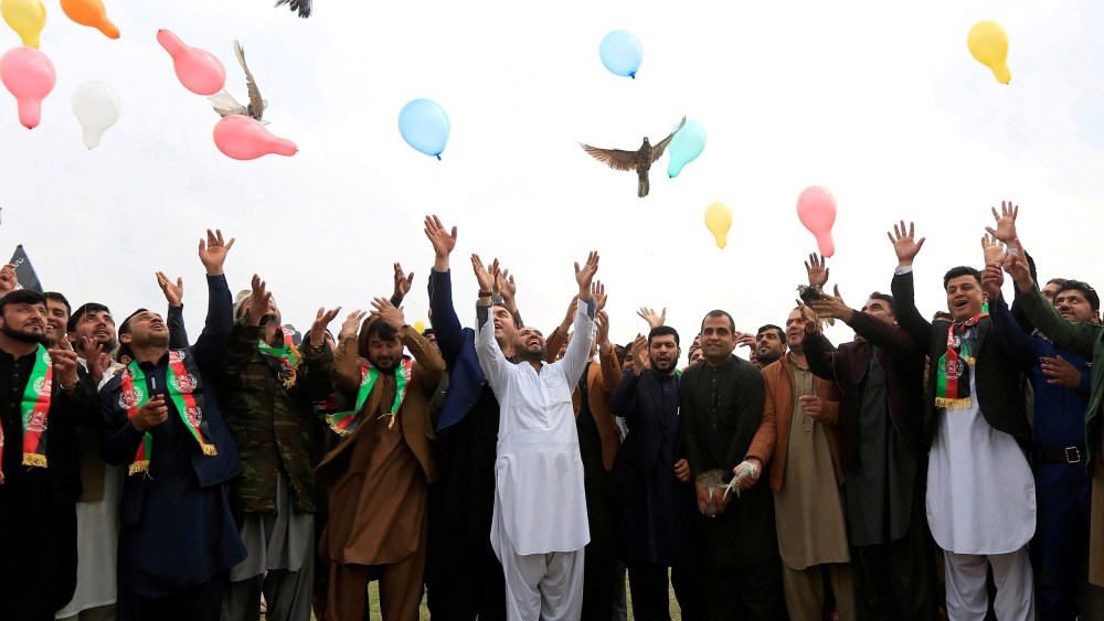 Image: Afghan men celebrate in anticipation of the U.S-Taliban agreement to allow a U.S. troop reduction and a permanent ceasefire, in Jalalabad