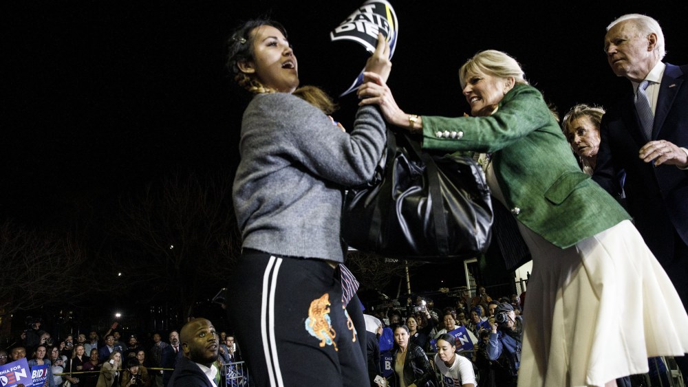 Image: Former Vice President Joe Biden, 2020 Democratic presidential candidate, right, watches as his wife Jill Biden, center, blocks a protester from arriving on stage during an primary night rally in the Baldwin Hills neighborhood of Los Angeles