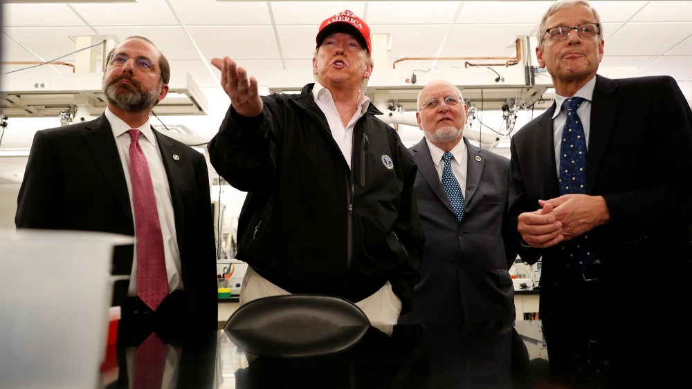 Image: President Donald Trump delivers remarks beside HHS Secretary Alex Azar and Centers for Disease Control, CDC Prevention Director Dr. Robert Redfield, and Associate Director for Laboratory Science and Safety Steve Monroe during a tour of the Center f