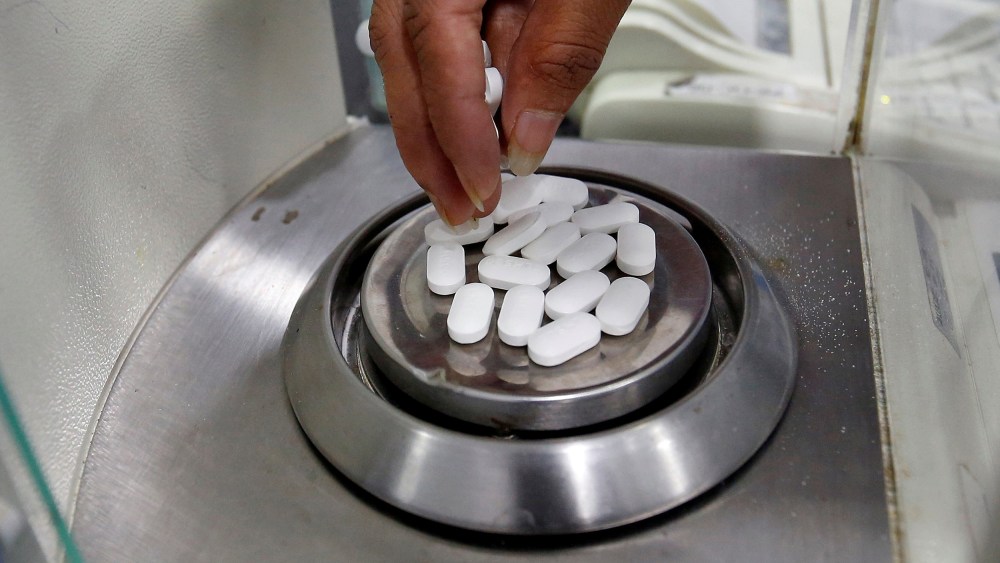 FILE PHOTO: A pharmacist checks weight of Paracetamol tablets inside a lab of a pharmaceutical company on the outskirts of Ahmedabad