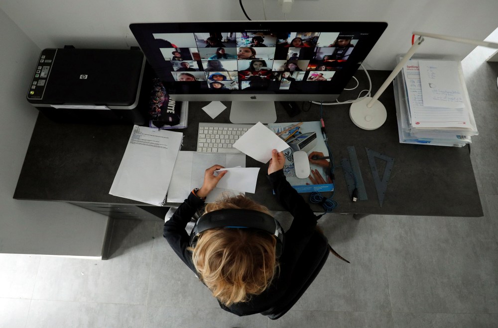 Image: A student takes classes online with his companions using the Zoom APP at home
