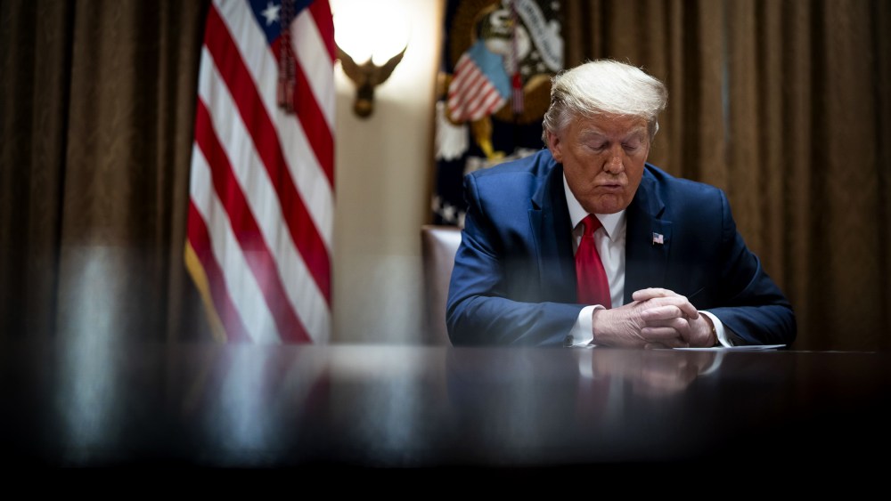 Image: President Donald Trump listens during a meeting in the Cabinet Room at the White House on April 14, 2020.