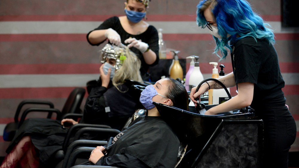 Image: Customers wear masks at a salon in Marietta, Ga., after the state reopened businesses and restaurants after restrictions to curb the spread of coronavirus on April 24, 2020.