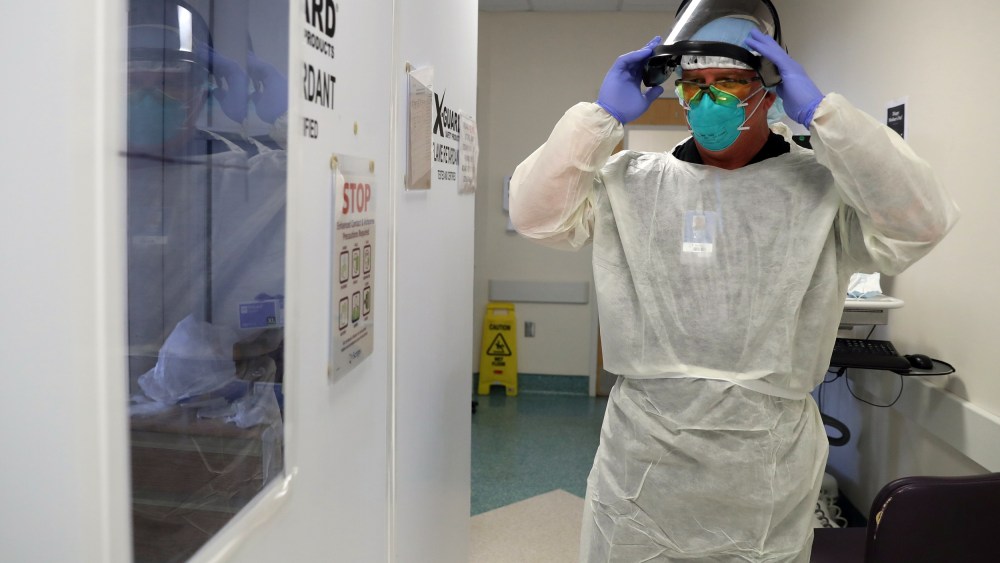 Image: Respiratory therapist Casey White prepares to attend to a patient suffering from the coronavirus disease (COVID-19) in the Intensive Care Unit (ICU), at Scripps Mercy Hospital in Chula Vista