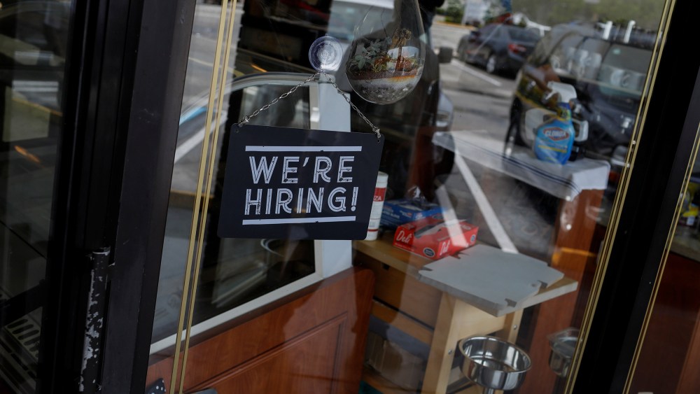 Image: A "We're Hiring" sign advertising jobs is seen at the entrance of a restaurant, as Miami-Dade County eases some of the lockdown measures put in place during the coronavirus disease (COVID-19) outbreak, in Miami