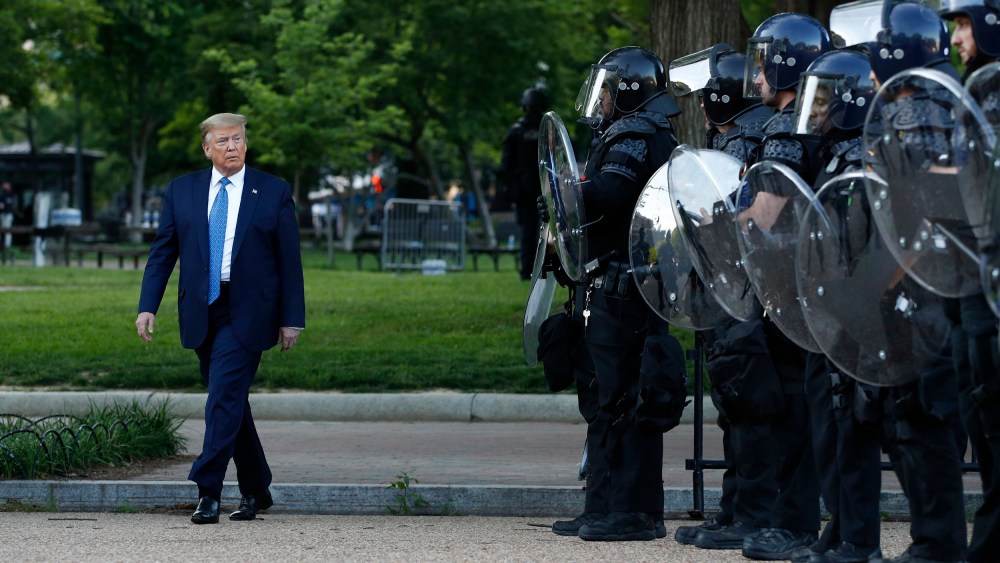 Image: President Donald Trump walks past police in Lafayette Park after visiting outside St. John's Church across from the White House Monday, June 1, 2020, in Washington.