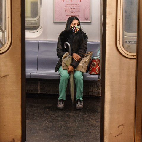 A passenger wears a mask while riding on a New York City subway train on May 6, 2020.