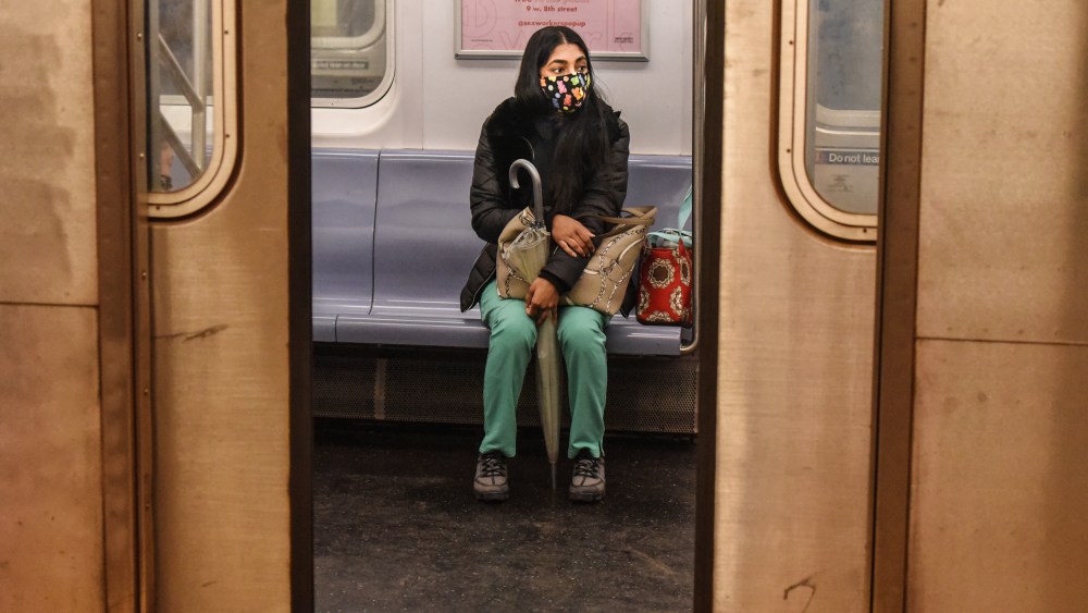 A passenger wears a mask while riding on a New York City subway train on May 6, 2020.