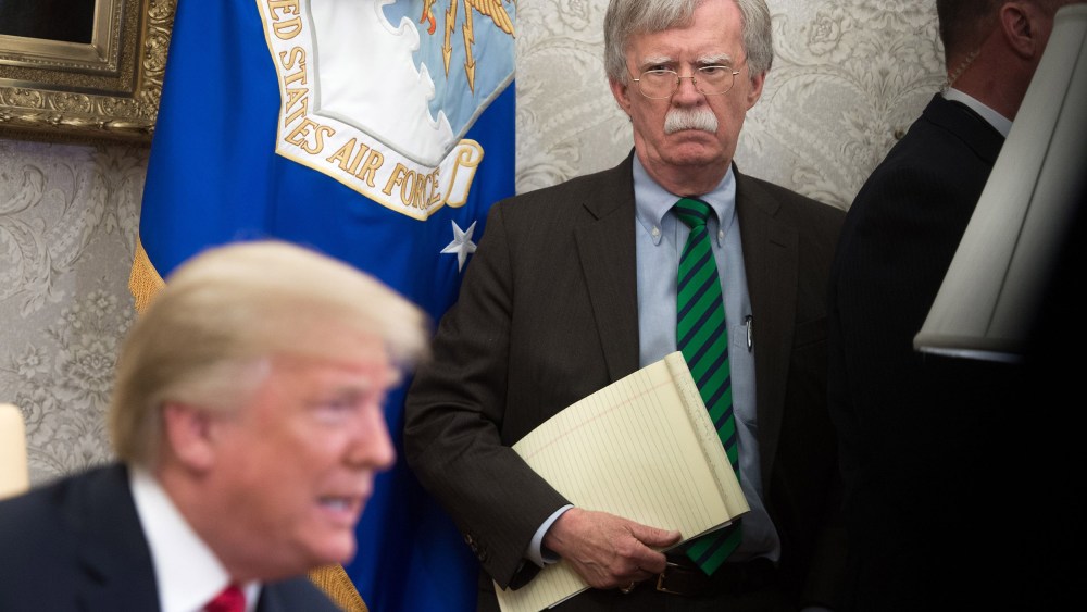 Image: National Security Adviser John Bolton stands alongside President Donald Trump as he speaks during a meeting in the Oval Office.