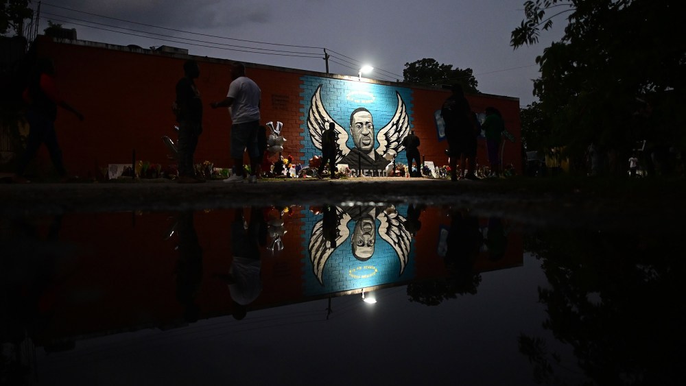 Image: People stand in front of a mural of George Floyd in Houston, Texas