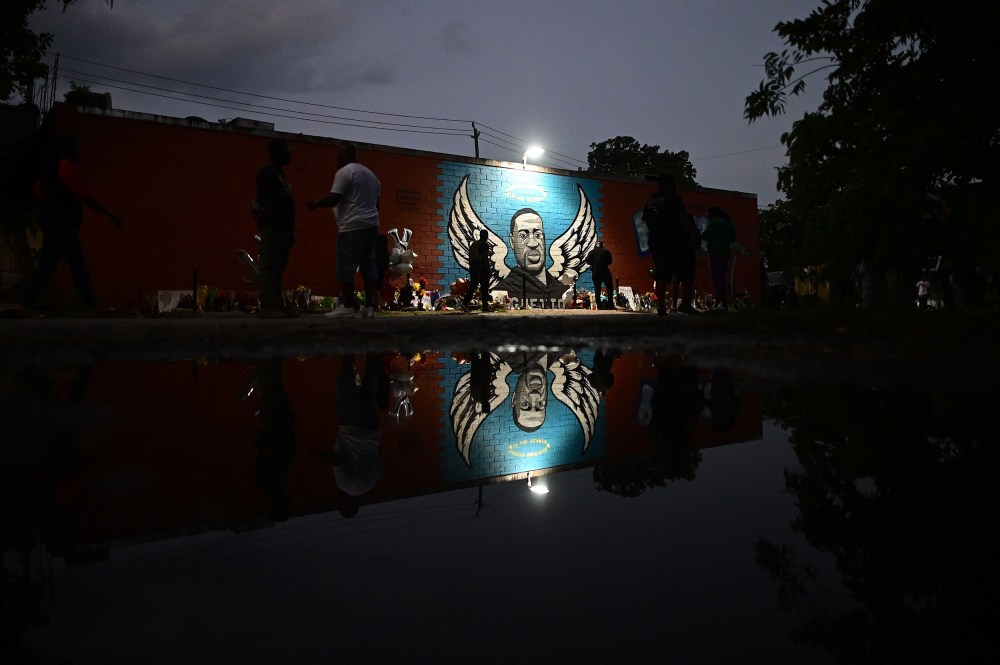 Image: People stand in front of a mural of George Floyd in Houston, Texas