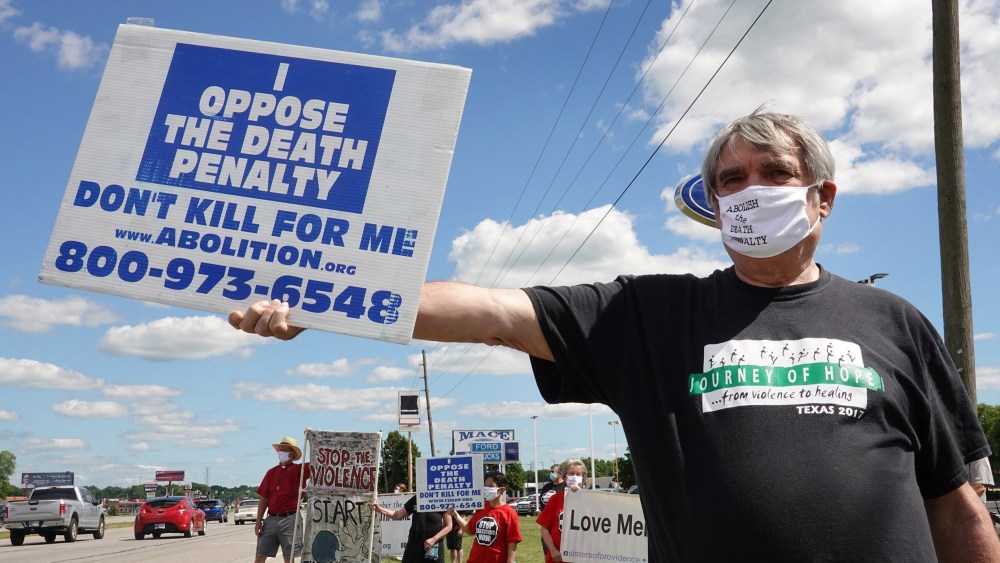 Image: Bill Pelke of Anchorage, Alaska expresses his opposition to the death penalty during a protest near the Federal Correctional Complex where Daniel Lewis Lee is scheduled to be executed