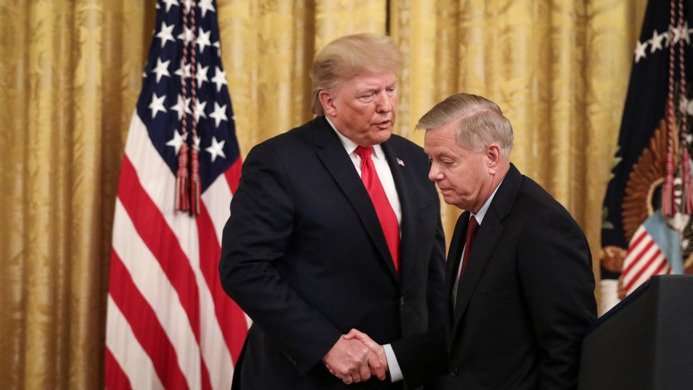 President Donald Trump shakes hands with Sen. Lindsey Graham, R-S.C., during an event at the White House on Nov. 6, 2019.