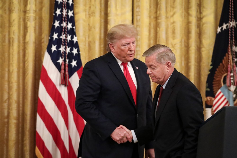 President Donald Trump shakes hands with Sen. Lindsey Graham, R-S.C., during an event at the White House on Nov. 6, 2019.