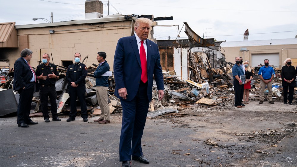 Image: President Donald Trump tours an area on Tuesday, Sept. 1, 2020, damaged during demonstrations after a police officer shot Jacob Blake in Kenosha, Wis.