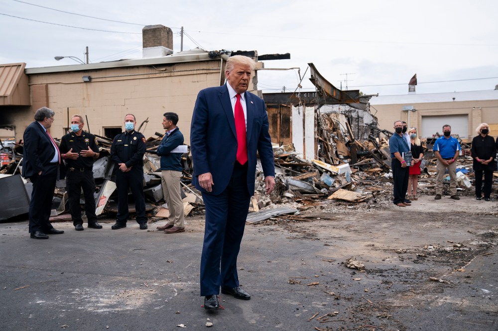 Image: President Donald Trump tours an area on Tuesday, Sept. 1, 2020, damaged during demonstrations after a police officer shot Jacob Blake in Kenosha, Wis.