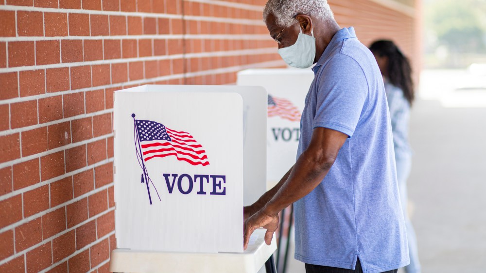 Senior Black Man Voting with a Mask