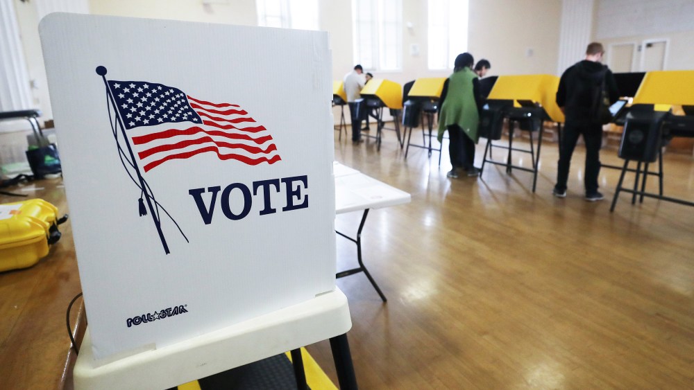 Image: Voters prepare their ballots in voting booths during early voting for the California presidential primary election at an L.A. County 'vote center'.