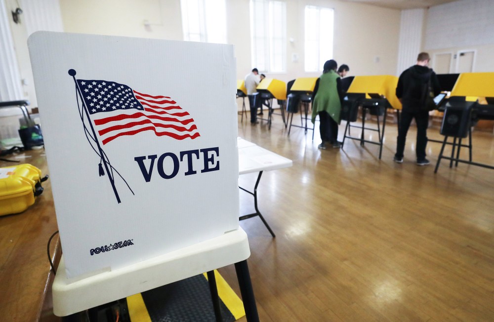Image: Voters prepare their ballots in voting booths during early voting for the California presidential primary election at an L.A. County 'vote center'.