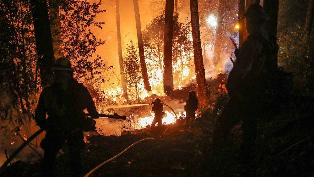 Image: Firefighters battle the Glass Fire as it encroaches towards a residence in Calistoga, California