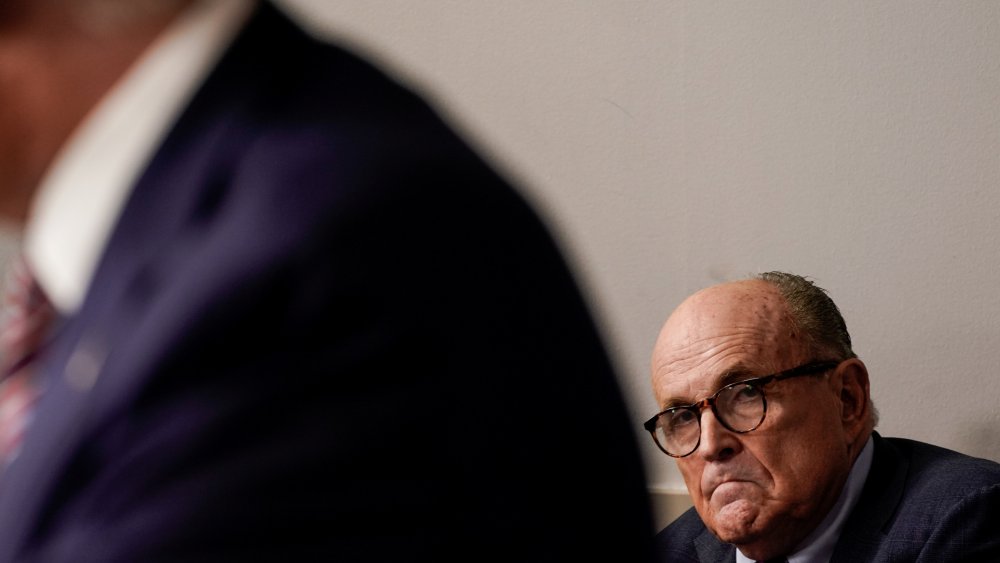 Image: Rudy Giuliani listens to U.S. President Trump speaks to reporters during a news conference