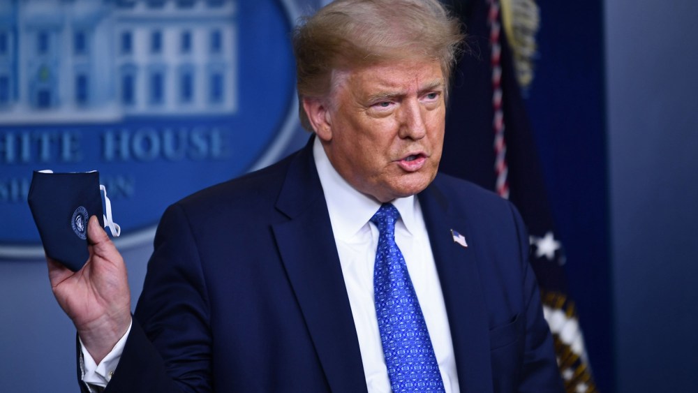 Image: President Donald Trump holds a facemask as he speaks to the press during the renewed briefing of the Coronavirus Task Force in the Brady Briefing Room of the White House.
