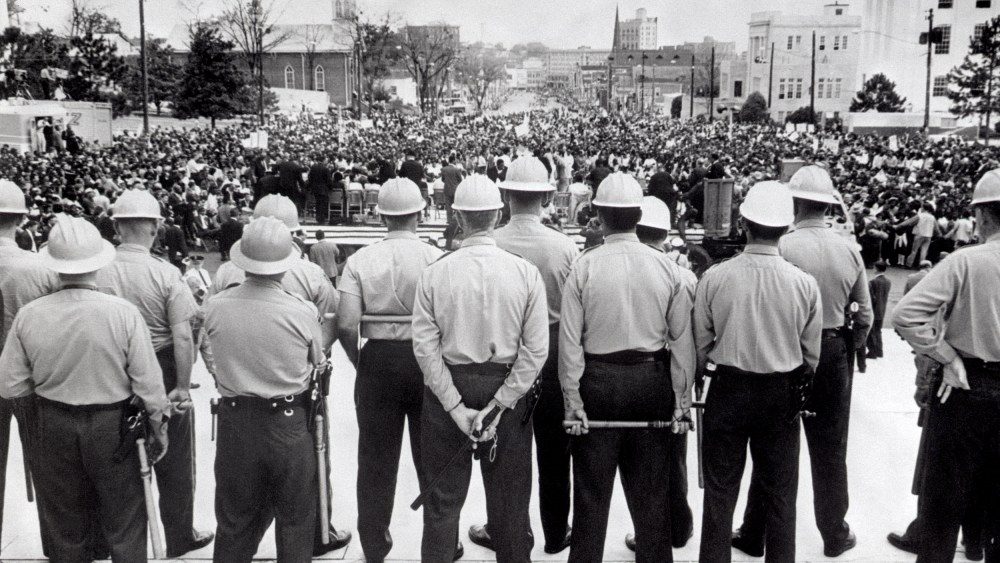 Image: State conservation agents, wielding nightsticks, watch as civil rights marchers arrive at the Alabama State Capitol in Montgomery, Ala., in 1965.