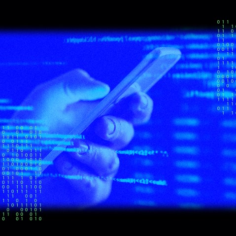Image: A hand holding a phone with an overlay of data