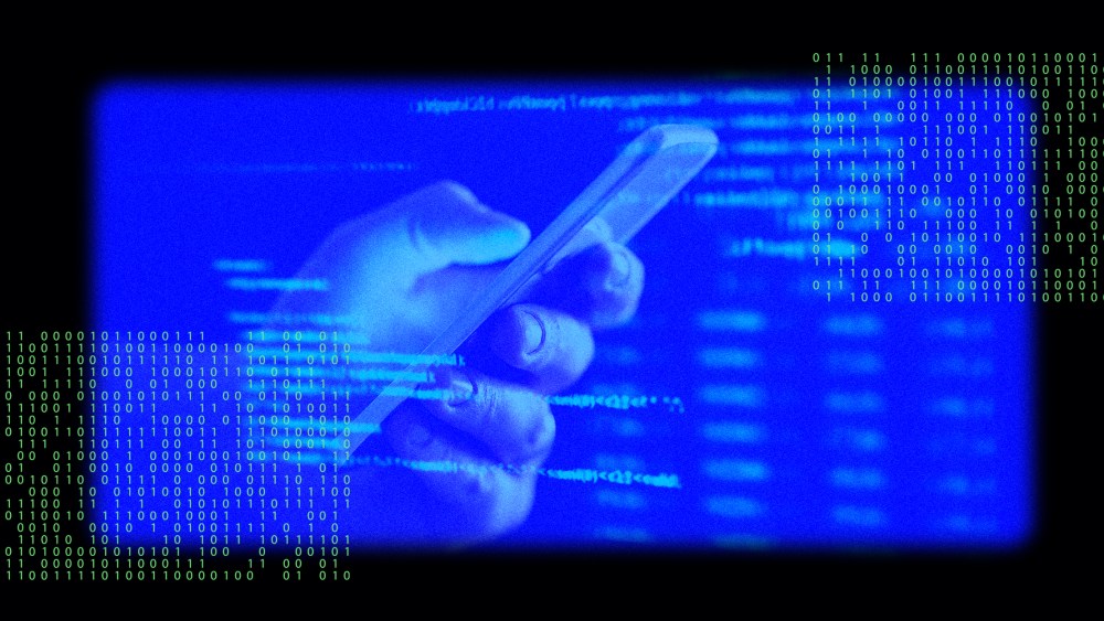 Image: A hand holding a phone with an overlay of data