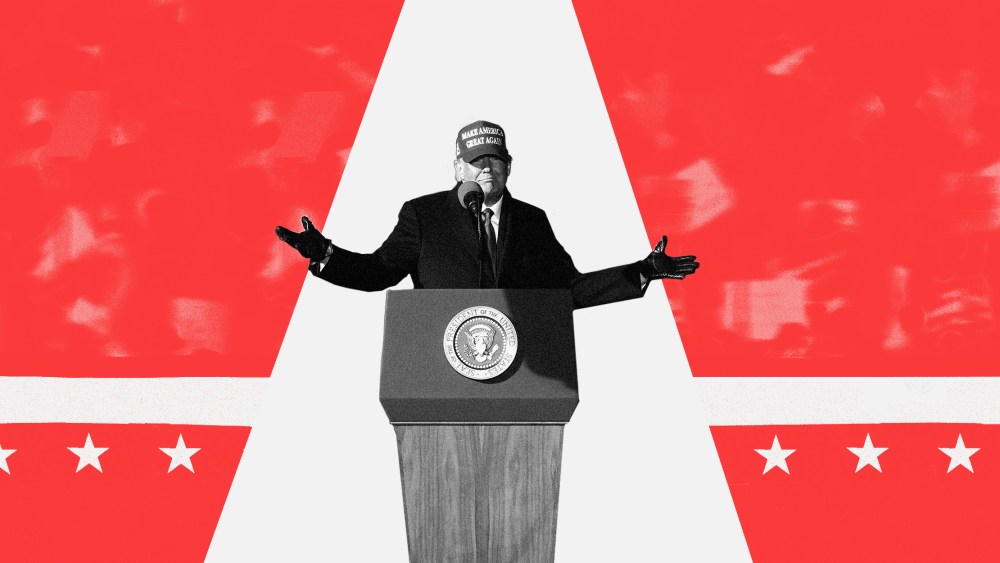 Image: Trump stands out in the limelight against a red blurry background of supporters