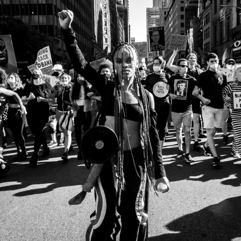 Image: Livia Johnson, an organizer with Warriors in the Garden, raises her fist as she marches with protesters through New York's Times Square on June 14, 2020.