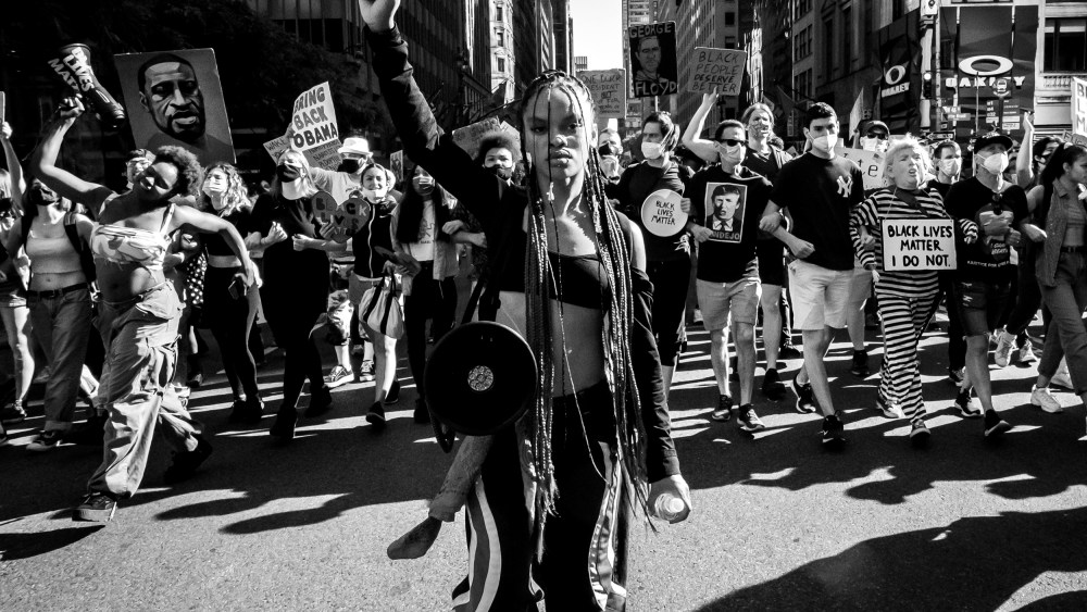 Image: Livia Johnson, an organizer with Warriors in the Garden, raises her fist as she marches with protesters through New York's Times Square on June 14, 2020.