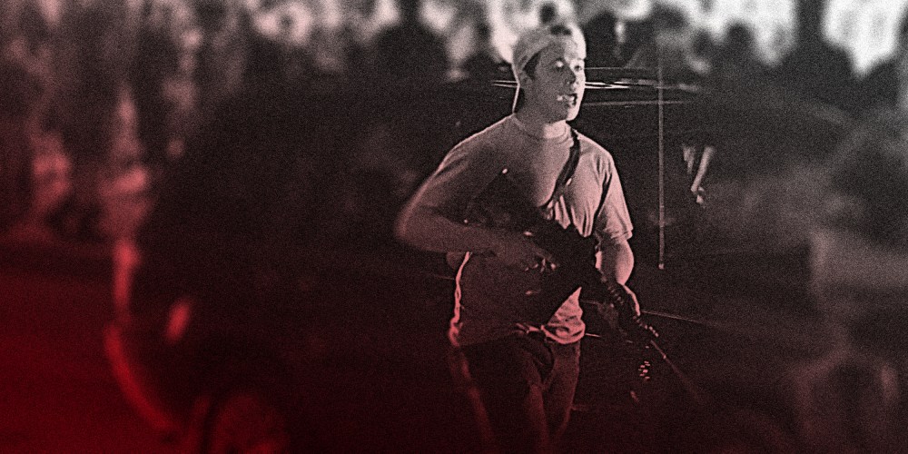 Image: Kyle Rittenhouse with a backwards cap and armed