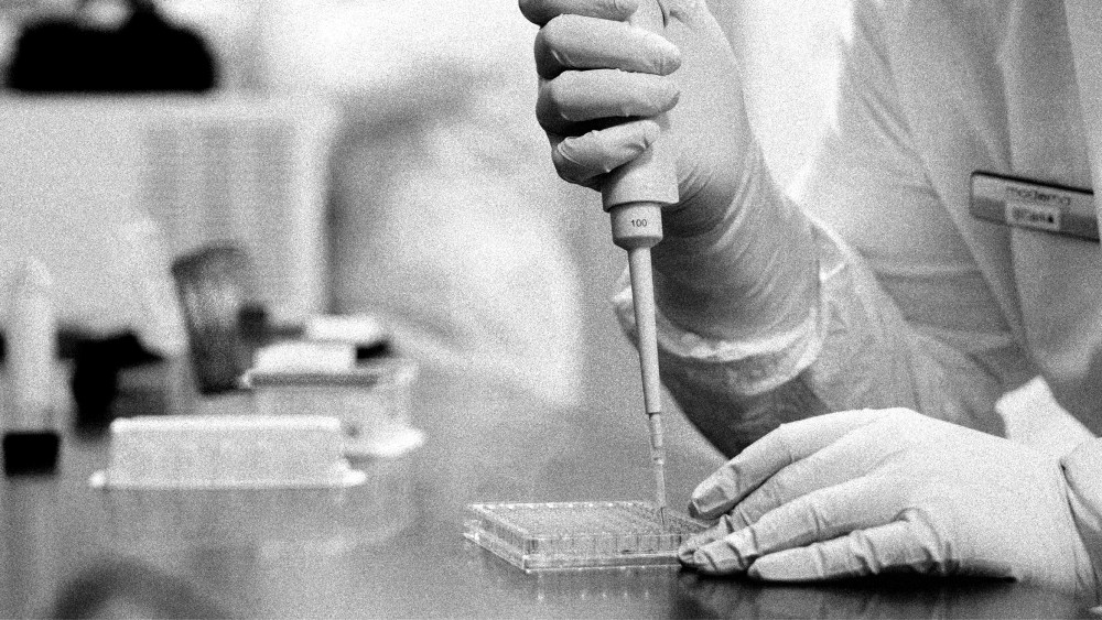 Image: A researcher works in a lab run by Moderna