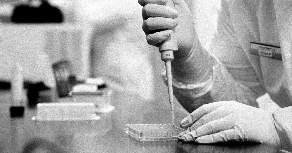 Image: A researcher works in a lab run by Moderna