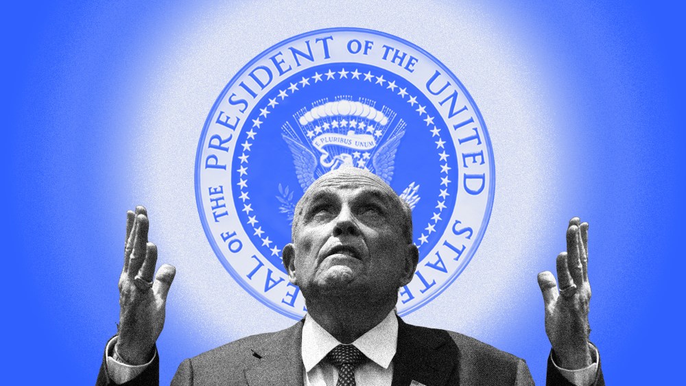 Image: Rudy Giuliani looks up with raised hands at a radiating US Presidential Seal