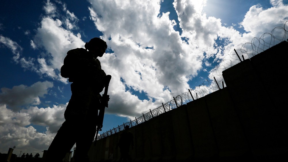 Image: U.S. soldiers stand guard at the K1 Air Base near Kirkuk in northern Iraq, during its handover ceremony
