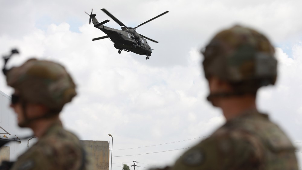 Image: U.S. soldiers stand guard at the K1 Air Base near Kirkuk in northern Iraq, during its handover ceremony