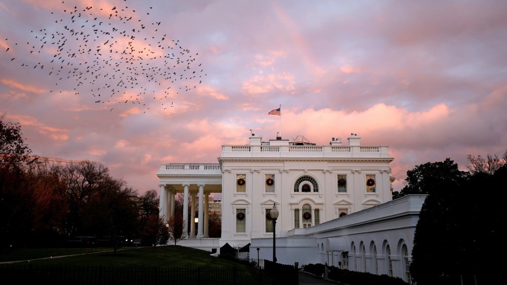 Image: A rainbow appears over the White House as birds fly nearby following a storm in Washington