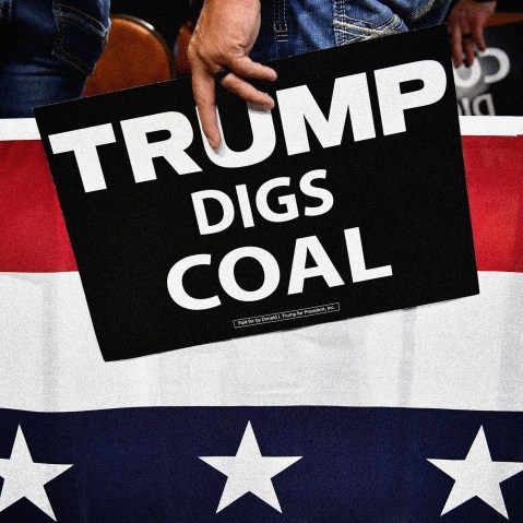 Image: A supporter of President Donald Trump holds a sign that reads "Trump Digs Coal" a rally in Charleston, W.V., on Aug. 21, 2018.
