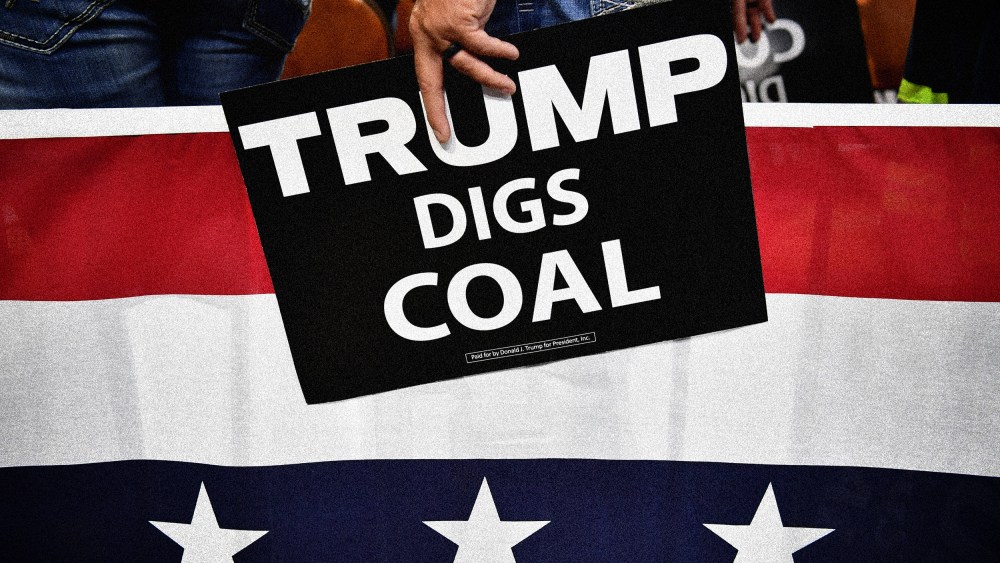 Image: A supporter of President Donald Trump holds a sign that reads "Trump Digs Coal" a rally in Charleston, W.V., on Aug. 21, 2018.